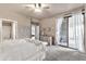 Serene bedroom with neutral tones, ceiling fan, and sliding glass doors to outdoor space at 15380 N 100Th St # 2098, Scottsdale, AZ 85260