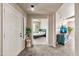 Home entryway featuring tile floors, a plant, and a view into the main bedroom at 15380 N 100Th St # 2098, Scottsdale, AZ 85260