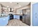 Well-lit kitchen with stainless steel appliances, blue cabinets, and custom open shelving at 15380 N 100Th St # 2098, Scottsdale, AZ 85260