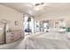 Bright main bedroom featuring sliding door balcony access, carpet floors, and large mirrored closet at 15380 N 100Th St # 2098, Scottsdale, AZ 85260