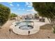 Landscaped backyard oasis featuring a sparkling pool, jacuzzi, tiki bar, and patio with plush seating at 15440 E Mustang Dr, Fountain Hills, AZ 85268