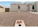 Spacious backyard featuring decorative stucco wall, cornhole game, and gravel ground cover at 15440 E Mustang Dr, Fountain Hills, AZ 85268