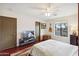 Bright bedroom features a ceiling fan, natural light, and ample space for relaxation and personalization at 15440 E Mustang Dr, Fountain Hills, AZ 85268