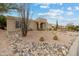 A Southwestern-style home with desert landscaping, gravel, and a rock border along the street at 15440 E Mustang Dr, Fountain Hills, AZ 85268