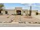 Southwest-style home featuring desert landscaping, a stone fountain, and a covered front porch at 15440 E Mustang Dr, Fountain Hills, AZ 85268