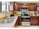 Modern kitchen featuring stainless steel appliances and a view from the window over the sink at 15440 E Mustang Dr, Fountain Hills, AZ 85268