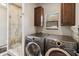 Laundry room with cabinetry, modern washer and dryer, plus glass enclosed walk-in shower at 15440 E Mustang Dr, Fountain Hills, AZ 85268