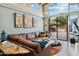 Well-lit living room with a large leather couch, decorative artwork and a view to the outdoor entertainment area at 15440 E Mustang Dr, Fountain Hills, AZ 85268