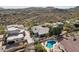 Aerial view of the property with a swimming pool, outdoor seating, and lush landscaping at 15510 E Sycamore Dr, Fountain Hills, AZ 85268