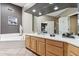 Well-lit bathroom with tiled floors, double sinks, and a separate bathtub at 15510 E Sycamore Dr, Fountain Hills, AZ 85268