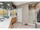 Bright bathroom featuring double sinks, tiled floors, and glass-enclosed shower at 15510 E Sycamore Dr, Fountain Hills, AZ 85268