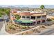 An outdoor American sports grill restaurant with palm trees on the corner of a building complex at 15510 E Sycamore Dr, Fountain Hills, AZ 85268