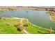 An aerial view shows the community lake with surrounding walkways and green spaces at 15510 E Sycamore Dr, Fountain Hills, AZ 85268