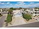 A charming light blue home with a tile roof, desert landscaping, and a spacious driveway leading to a two-car garage at 15510 E Sycamore Dr, Fountain Hills, AZ 85268