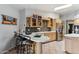 Bright kitchen featuring tile floors, a breakfast bar, and stainless steel refrigerator at 15510 E Sycamore Dr, Fountain Hills, AZ 85268