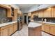 Spacious kitchen with stainless steel appliances, a kitchen island, and tile floors at 15510 E Sycamore Dr, Fountain Hills, AZ 85268