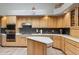 Bright kitchen with stainless steel oven, island, and custom wooden cabinets at 15510 E Sycamore Dr, Fountain Hills, AZ 85268