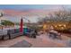 Outdoor patio featuring cozy seating, a table, and a vibrant umbrella, ideal for relaxing and enjoying mountain views at 15510 E Sycamore Dr, Fountain Hills, AZ 85268