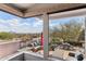 Scenic view of a patio framed by expansive glass windows, offering stunning vistas of the mountains and landscape at 15510 E Sycamore Dr, Fountain Hills, AZ 85268