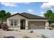 Charming single-story home featuring desert landscaping and a two-car garage, perfect for low-maintenance living at 15648 W Deanne Dr, Waddell, AZ 85355