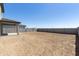 Expansive backyard with privacy block fence and covered patio, ready for custom landscaping at 15675 W Mercer Ln, Surprise, AZ 85379