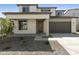 Charming two-story home featuring a neutral color palette, well-kept landscaping, and an attached two-car garage at 15675 W Mercer Ln, Surprise, AZ 85379