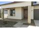 Welcoming front porch with neutral colors, desert landscaping, and a stylish front door at 15675 W Mercer Ln, Surprise, AZ 85379