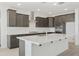 Contemporary kitchen featuring a large island, stainless steel appliances, and sleek white backsplash at 15675 W Mercer Ln, Surprise, AZ 85379