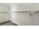 Walk-in closet features a carpeted floor and closet rod to hang your clothes at 15675 W Mercer Ln, Surprise, AZ 85379