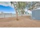 View of large backyard showcasing gravel landscaping, shade trees, and fenced perimeter for enhanced privacy at 1669 N Suncrest Ave, Casa Grande, AZ 85122