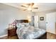 Cozy bedroom with a ceiling fan, wood-look flooring and a comfortable-looking patchwork quilt on the bed at 1669 N Suncrest Ave, Casa Grande, AZ 85122