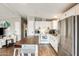 Charming kitchen with island, white cabinets, and modern appliances, seamlessly connecting to the living room at 1669 N Suncrest Ave, Casa Grande, AZ 85122