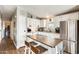 Bright kitchen featuring white cabinets, stainless steel appliances, and a wooden island with seating at 1669 N Suncrest Ave, Casa Grande, AZ 85122