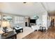 Comfortable living room featuring wood floors and abundant natural light at 1669 N Suncrest Ave, Casa Grande, AZ 85122