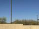 Desert landscape with trees visible above the wall at 1708 W Dusty Wren Dr, Phoenix, AZ 85085