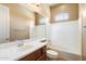 Well-lit bathroom featuring a single sink vanity and tiled shower and tub combo at 1708 W Dusty Wren Dr, Phoenix, AZ 85085