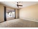 Spacious bedroom with a large window providing natural light and neutral-toned carpeting at 1708 W Dusty Wren Dr, Phoenix, AZ 85085