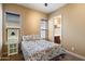 Cozy bedroom with a floral patterned bedspread and natural light from large window at 1708 W Dusty Wren Dr, Phoenix, AZ 85085