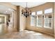 Elegant dining area with ample natural light and a stylish chandelier at 1708 W Dusty Wren Dr, Phoenix, AZ 85085