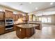 Modern kitchen featuring an island with a sink, granite countertops, and wood cabinetry at 1708 W Dusty Wren Dr, Phoenix, AZ 85085