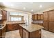 Spacious kitchen featuring granite countertops, tile flooring, and stainless steel appliances at 1708 W Dusty Wren Dr, Phoenix, AZ 85085