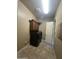 Well-lit laundry room featuring black washer and dryer, overhead cabinets, and tile flooring at 1708 W Dusty Wren Dr, Phoenix, AZ 85085