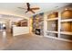 Open-concept living area with a stone fireplace and built-in shelving at 1708 W Dusty Wren Dr, Phoenix, AZ 85085