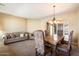 Inviting living room with carpeted floors, a large dining table, and warm, neutral tones at 1708 W Dusty Wren Dr, Phoenix, AZ 85085