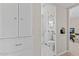 Bright bathroom featuring a white vanity and toilet, complemented by marble tile floors and built-in cabinets at 171 W Tulsa St, Chandler, AZ 85225