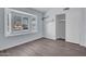 This bedroom features wood-look floors, a bay window, shelves, and a sliding door closet at 1717 E Sandra Ter, Phoenix, AZ 85022