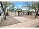 This single story home has a gravel yard, an attached garage, and a green roof at 1717 E Sandra Ter, Phoenix, AZ 85022