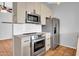 A bright, updated kitchen with stainless steel appliances and white countertops at 1717 E Sandra Ter, Phoenix, AZ 85022