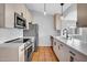 A bright, updated kitchen with stainless steel appliances and white countertops at 1717 E Sandra Ter, Phoenix, AZ 85022