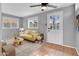 The living room has neutral walls, a yellow sofa, a ceiling fan, and a white door at 1717 E Sandra Ter, Phoenix, AZ 85022